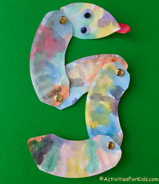 Easy and inexpensive to make, paper plate snake craft for kids.  Cut apart in sections for a bendable snake.  Kids crafts for St. Patrick's Day, Chinese New Year or Bible Study of Adam and Eve.  ActivitiesForKids.com 