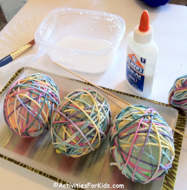 Yarn Easter Egg craft for kids using glue and water.